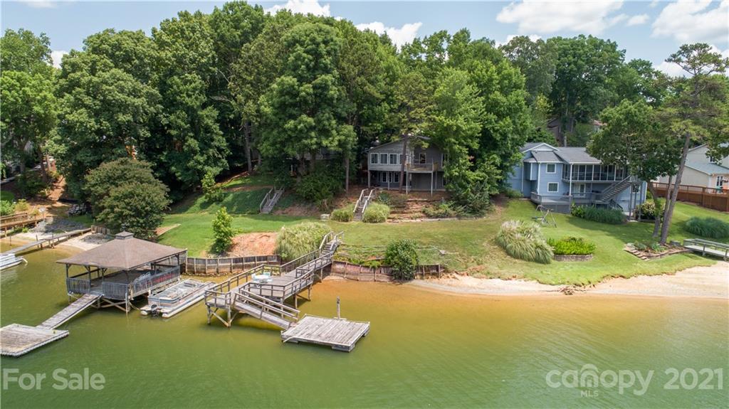 7017 Chelsea Day Lane Tega Cay, SC 29708 - Photo 42 of 48 a view of backyard with swimming pool and trees in the background