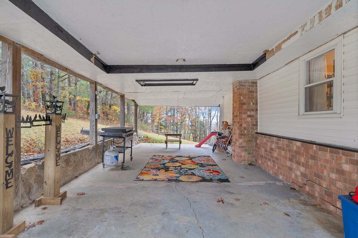 446 Macks Mountain Road Northwest Indian Valley, VA 24105 - Photo 20 of 59 a bed room with a bed and large windows