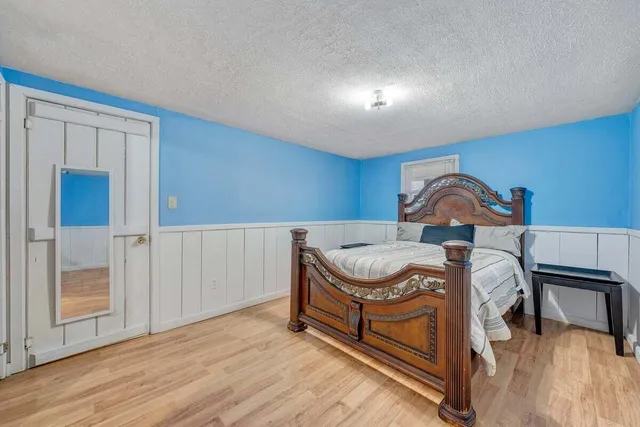 a view of a kitchen with wooden floor and a window