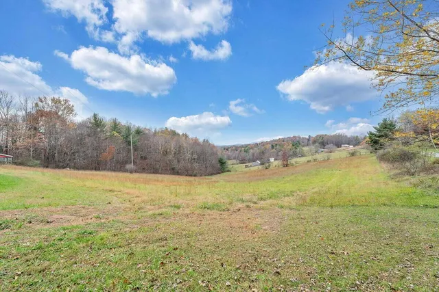 a view of a house with wooden fence and a porch
