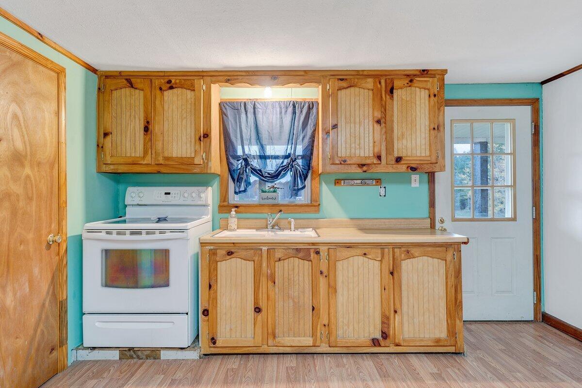 446 Macks Mountain Road Northwest Indian Valley, VA 24105 - Photo 32 of 59 a kitchen with a stove a sink and a refrigerator