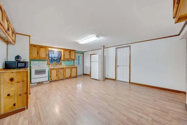 a very nice looking room with a large window and furniture
