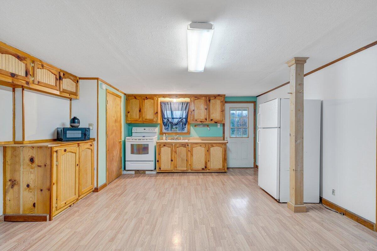 446 Macks Mountain Road Northwest Indian Valley, VA 24105 - Photo 34 of 59 a view of a kitchen with wooden floor and a window
