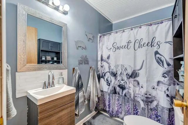 a kitchen with stainless steel appliances kitchen island granite countertop a sink cabinets and wooden floor