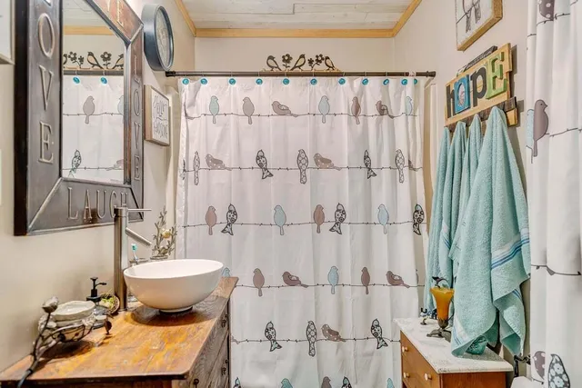 a living room with furniture a fireplace and a chandelier