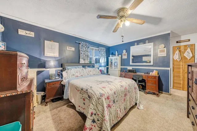 a living room with furniture kitchen view and a chandelier