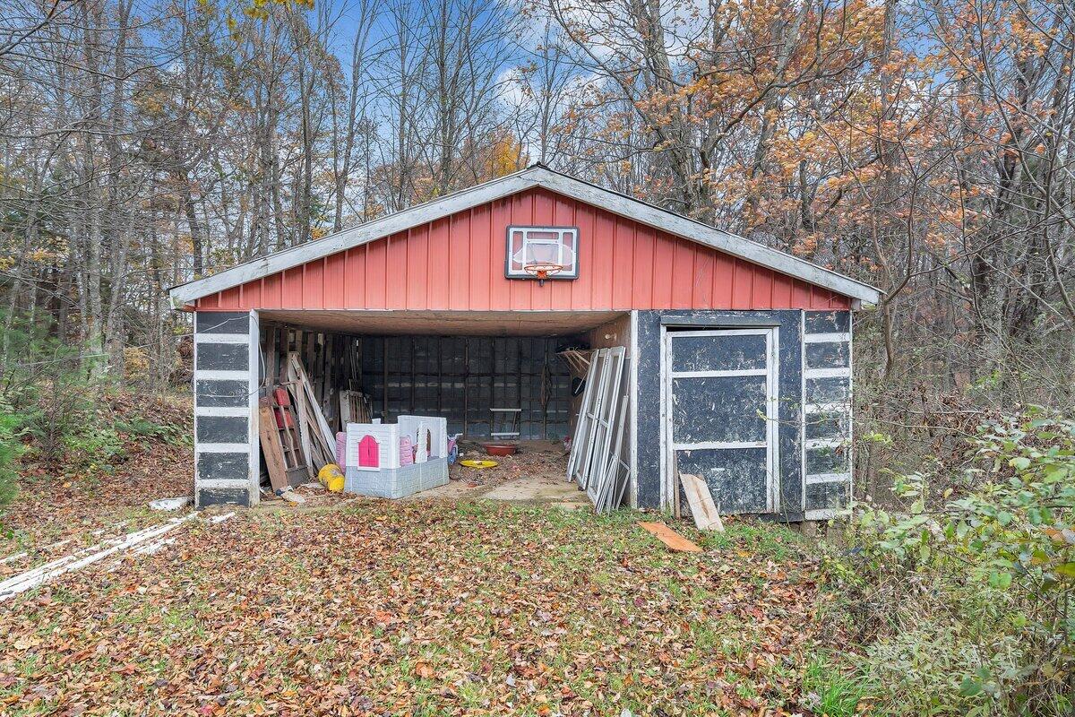 446 Macks Mountain Road Northwest Indian Valley, VA 24105 - Photo 5 of 59 a view of a house with wooden fence and a porch