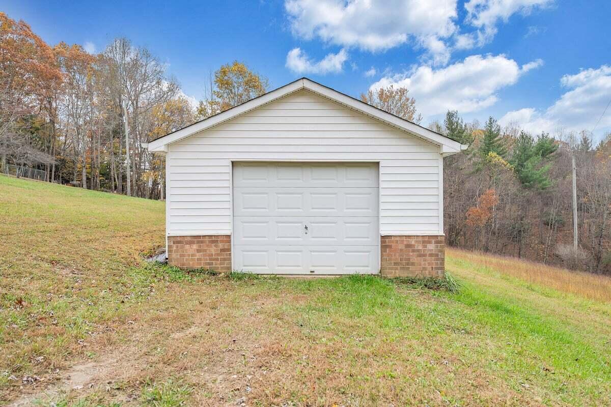 446 Macks Mountain Road Northwest Indian Valley, VA 24105 - Photo 9 of 59 a view of a backyard with plants and large tree