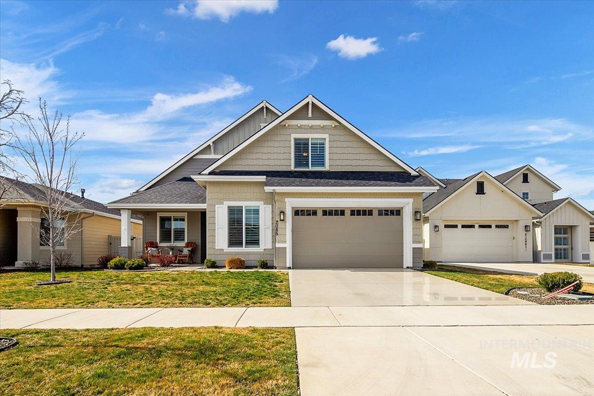 2085 North Concha Court Middleton, ID 83644 - Photo 1 of 37 Craftsman house with driveway, a front lawn, covered porch, an attached garage, and roof with shingles