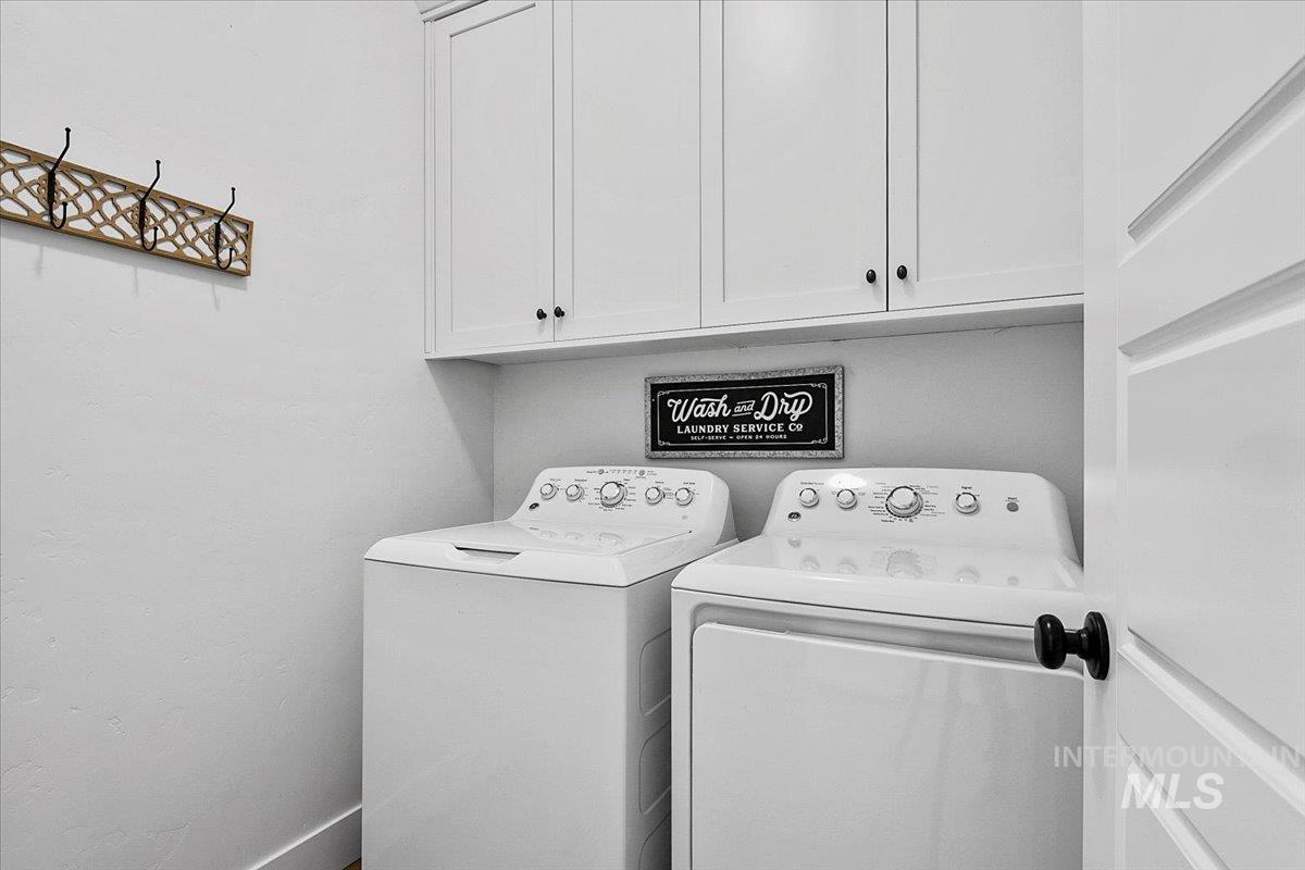 2085 North Concha Court Middleton, ID 83644 - Photo 16 of 37 Laundry area featuring independent washer and dryer and cabinet space