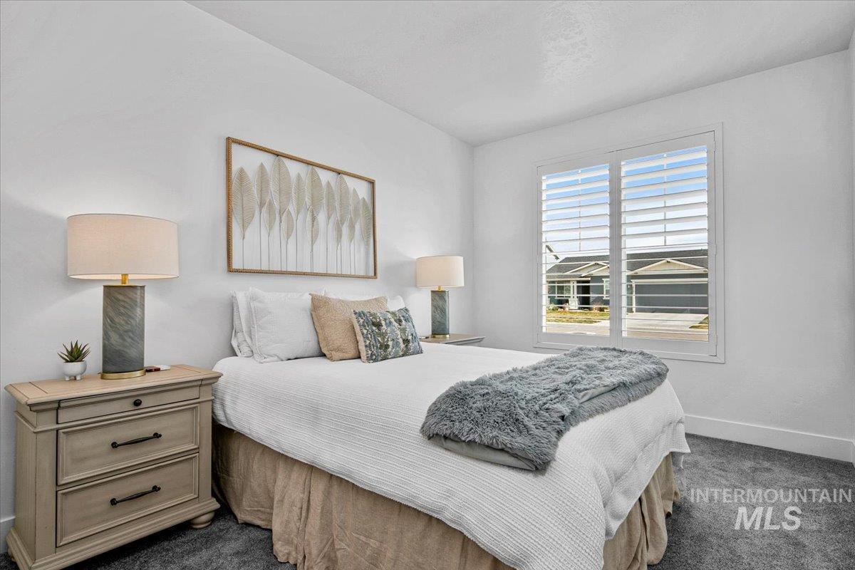 2085 North Concha Court Middleton, ID 83644 - Photo 23 of 37 Bedroom with dark colored carpet and baseboards