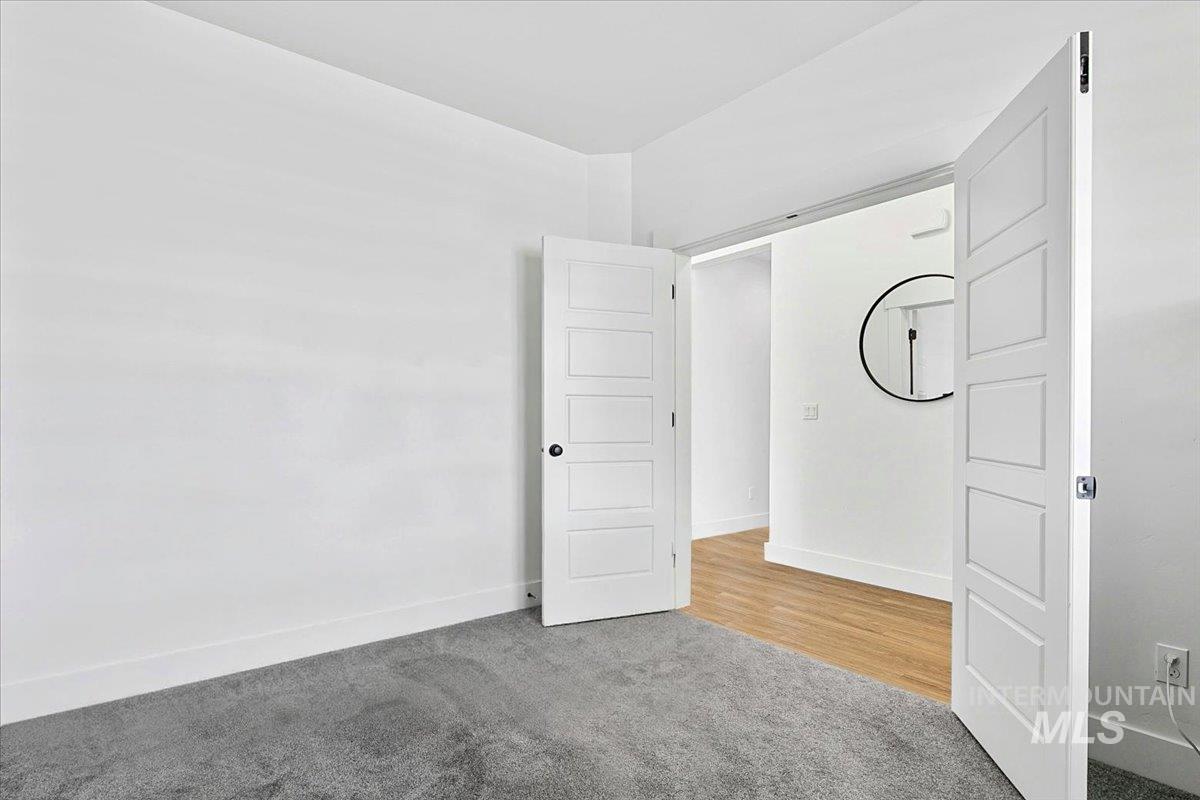 2085 North Concha Court Middleton, ID 83644 - Photo 28 of 37 Unfurnished bedroom featuring light carpet and baseboards