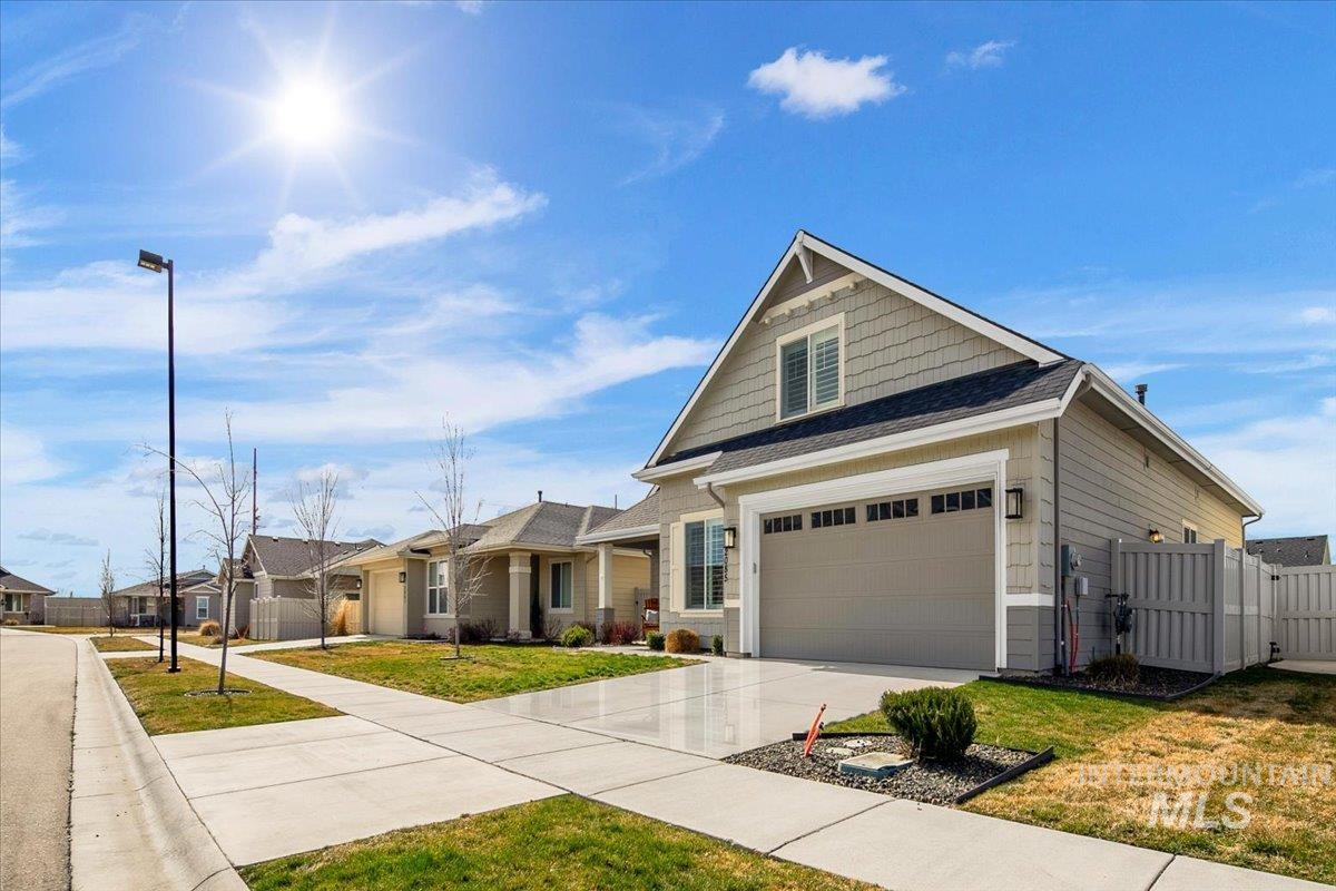 2085 North Concha Court Middleton, ID 83644 - Photo 3 of 37 Craftsman-style house featuring a gate, concrete driveway, a shingled roof, and a residential view