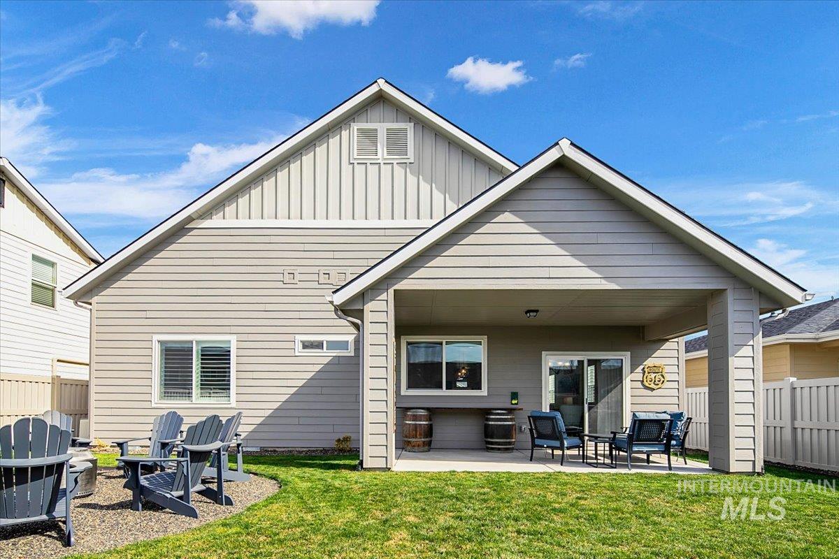 2085 North Concha Court Middleton, ID 83644 - Photo 34 of 37 Back of house featuring a patio area, board and batten siding, and a fire pit