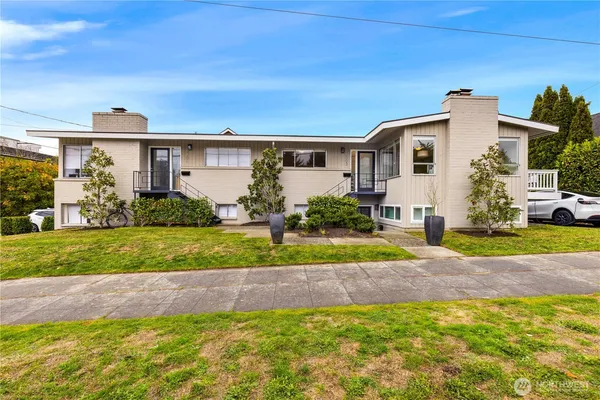 a view of a house with a yard and plants