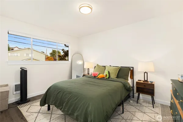 a bed sitting in a bedroom next to a lamp