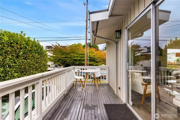 a view of balcony with chairs and wooden fence