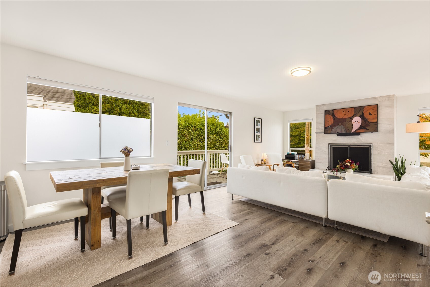 6301 22nd Avenue Northwest Seattle, WA 98107 - Photo 9 of 19 a living room with furniture a fireplace and a large window