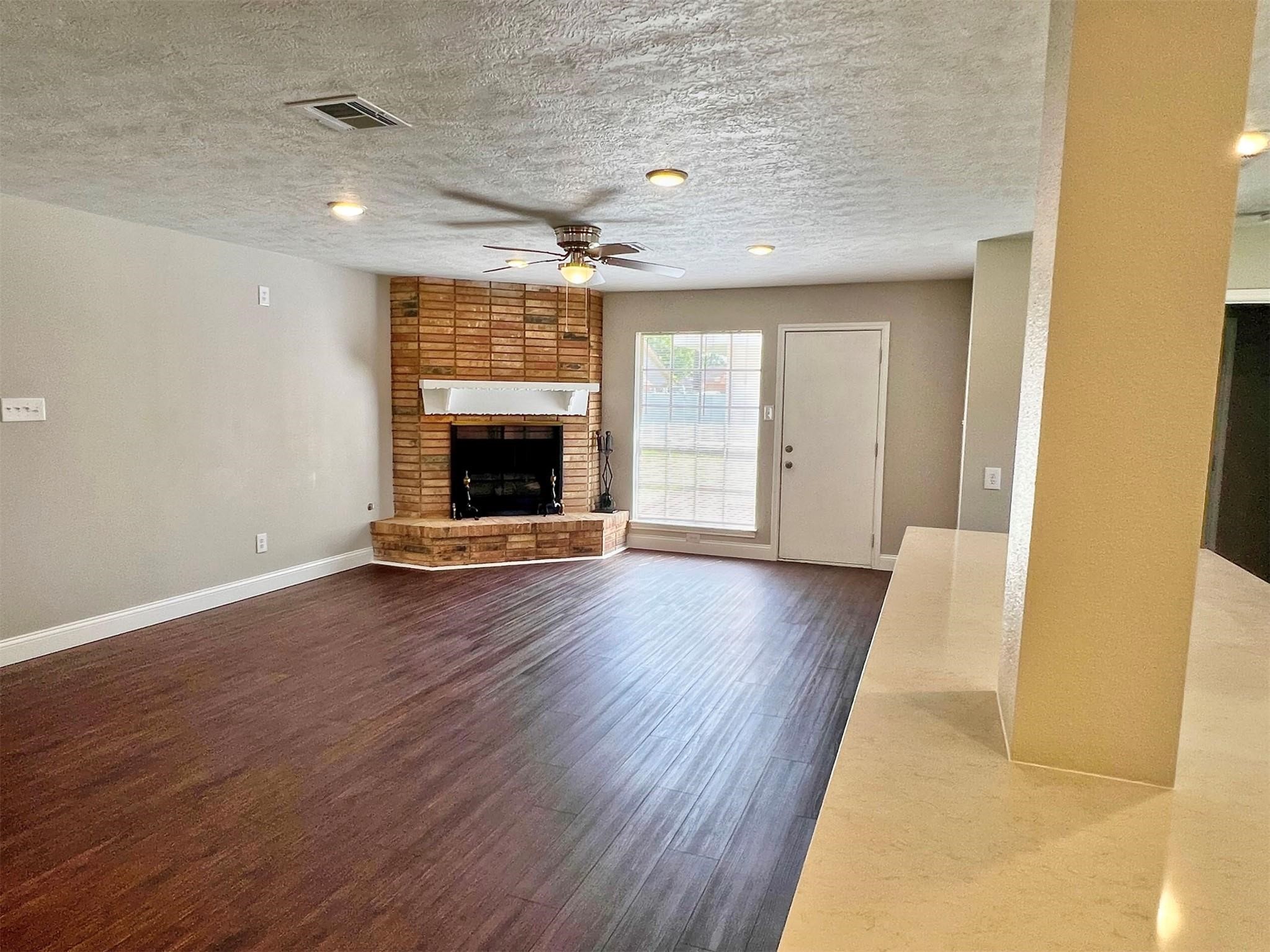 415 Sevenhampton Lane Houston, TX 77015 - Photo 5 of 28 Open concept living featuring a gas fireplace