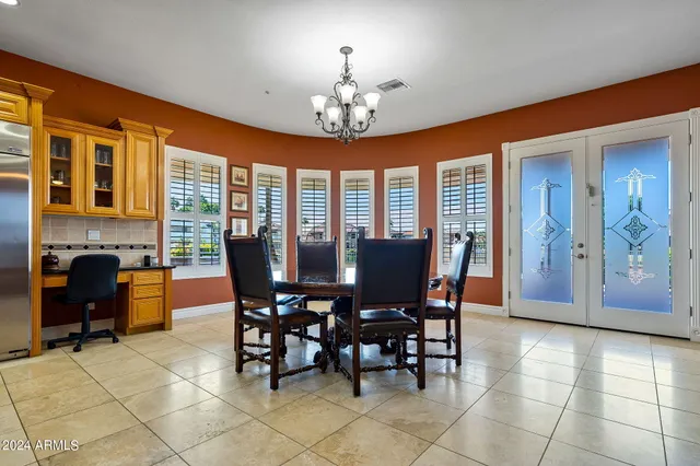 a dining room with furniture and chandelier kitchen view