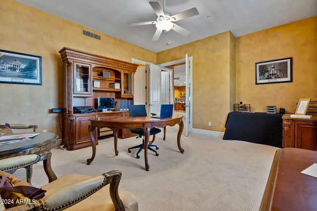 a view of a livingroom with furniture and a ceiling fan
