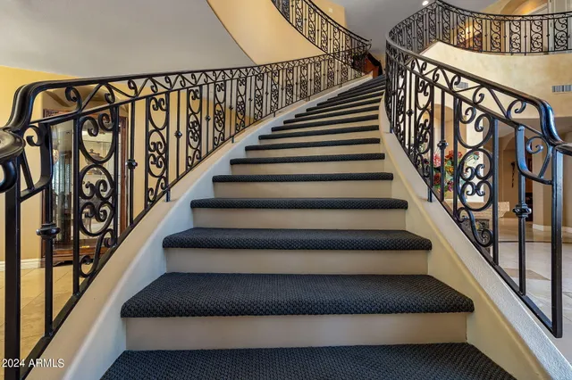 a spacious bedroom with a bed and a fireplace