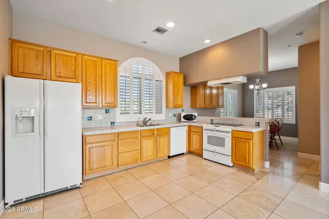 a bathroom with a granite countertop toilet sink and shower