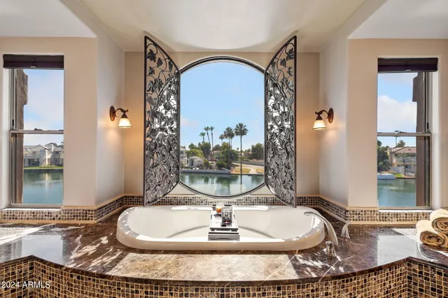 a bedroom with furniture and a large window