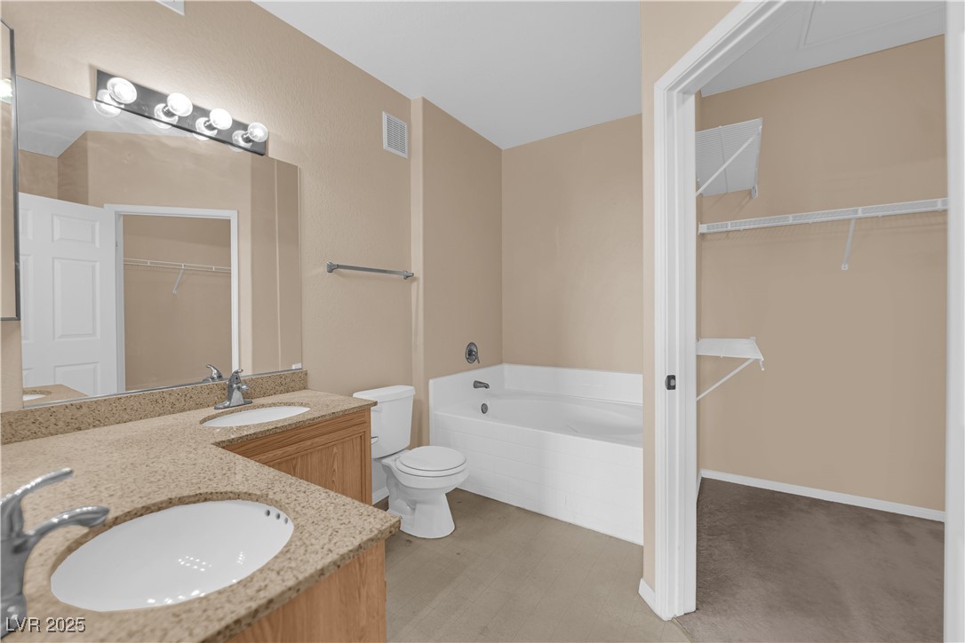 10550 West Alexander Road, Unit 2233 Las Vegas, NV 89129 - Photo 18 of 35 Full bathroom with a sink, toilet, a garden tub, and visible vents