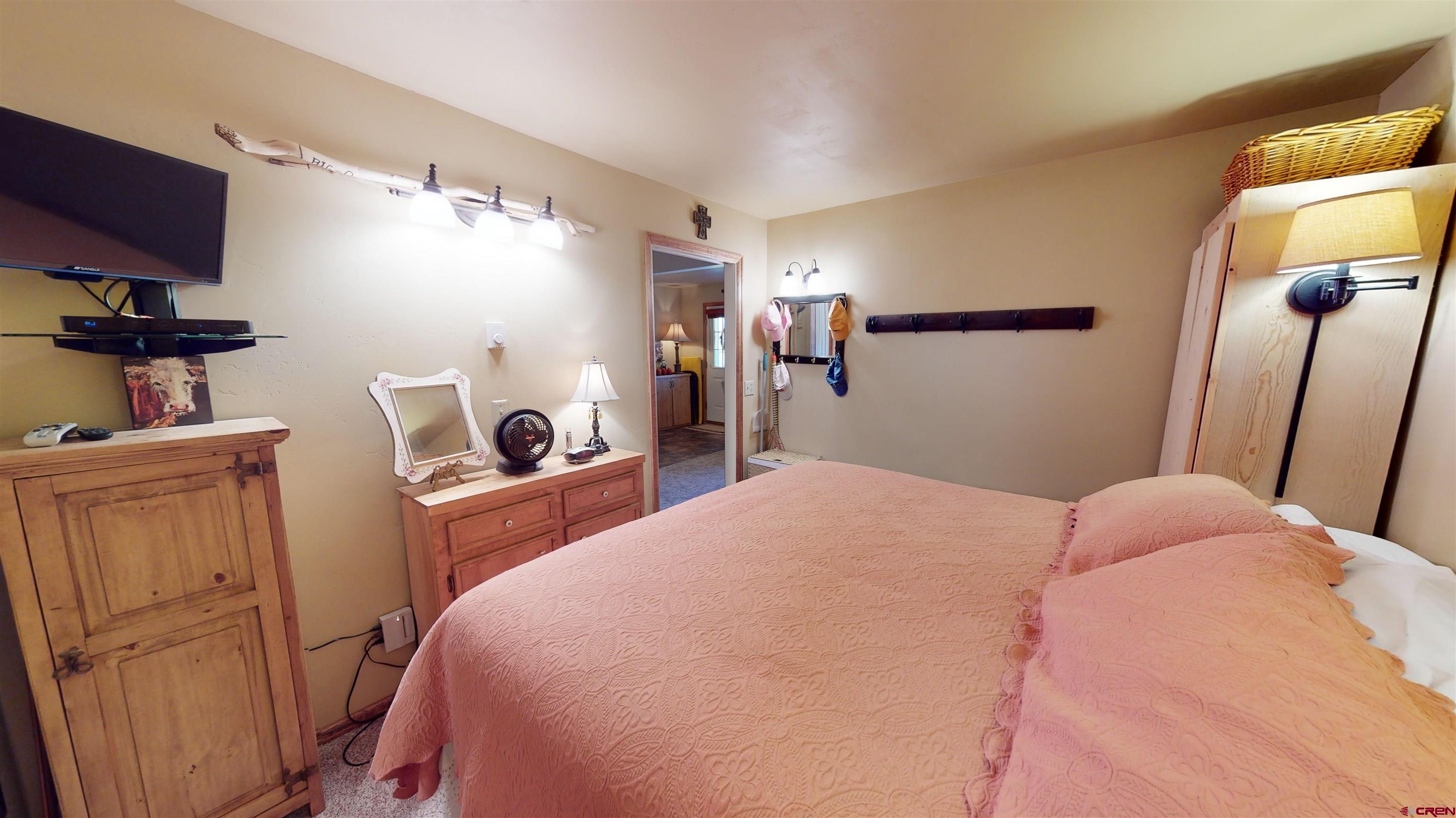 18 Crystal Road, Unit 2C Crested Butte, CO 81225 - Photo 14 of 23 a bedroom with a bed and a flat tv screen on the dresser