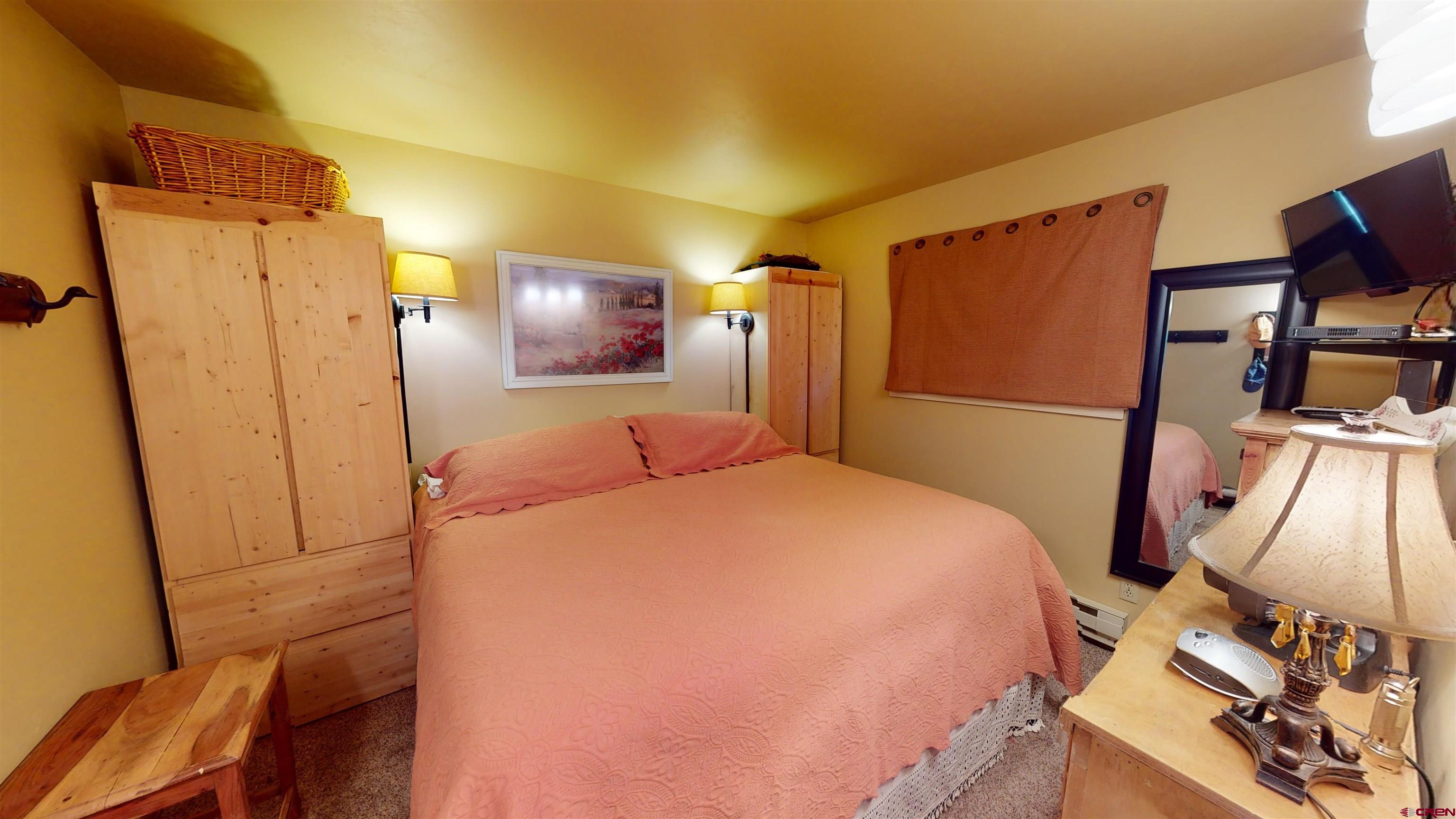 18 Crystal Road, Unit 2C Crested Butte, CO 81225 - Photo 15 of 23 a bed room with a bed and a mirror