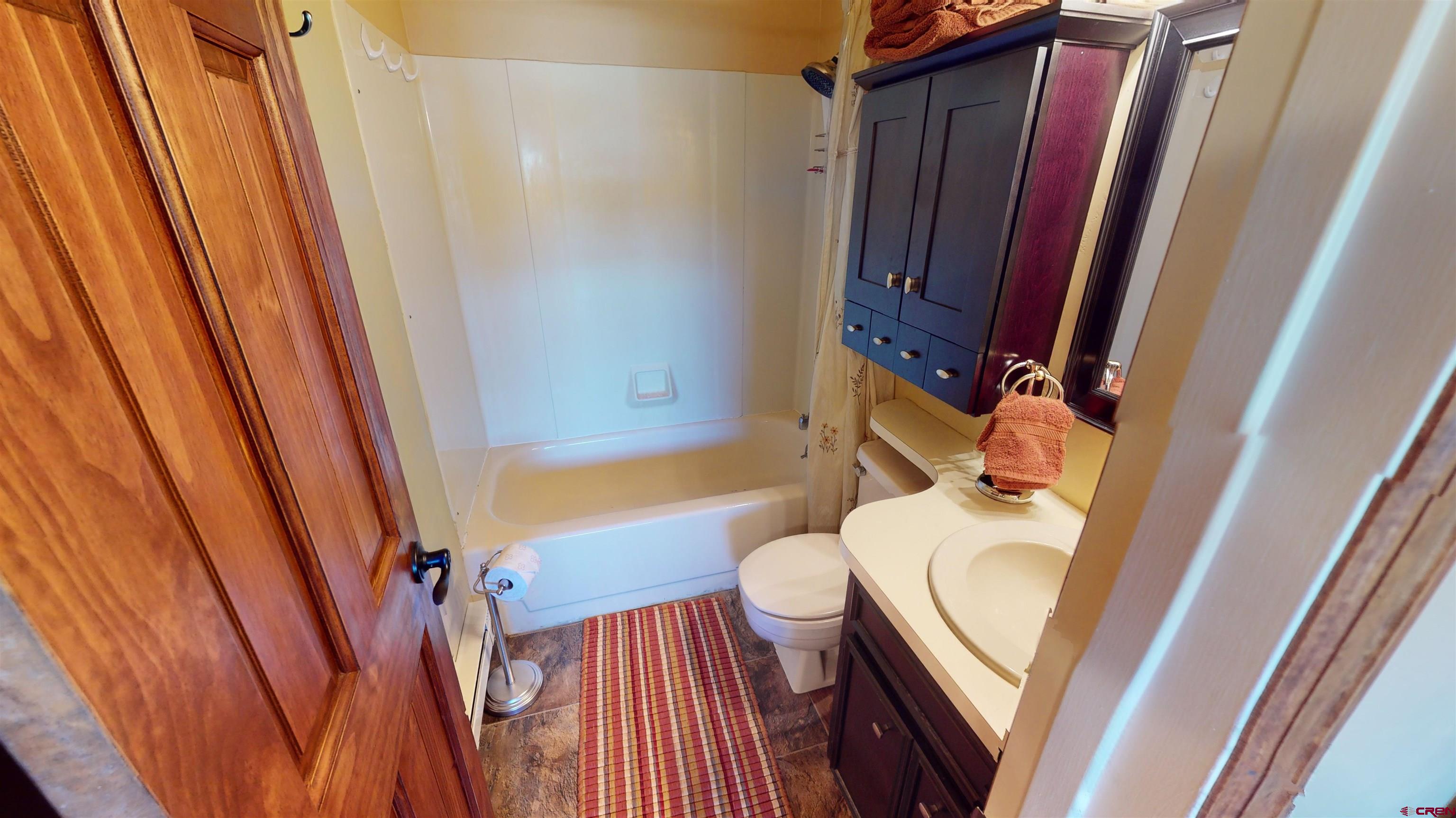 18 Crystal Road, Unit 2C Crested Butte, CO 81225 - Photo 18 of 23 a bathroom with a toilet a sink and a bathtub