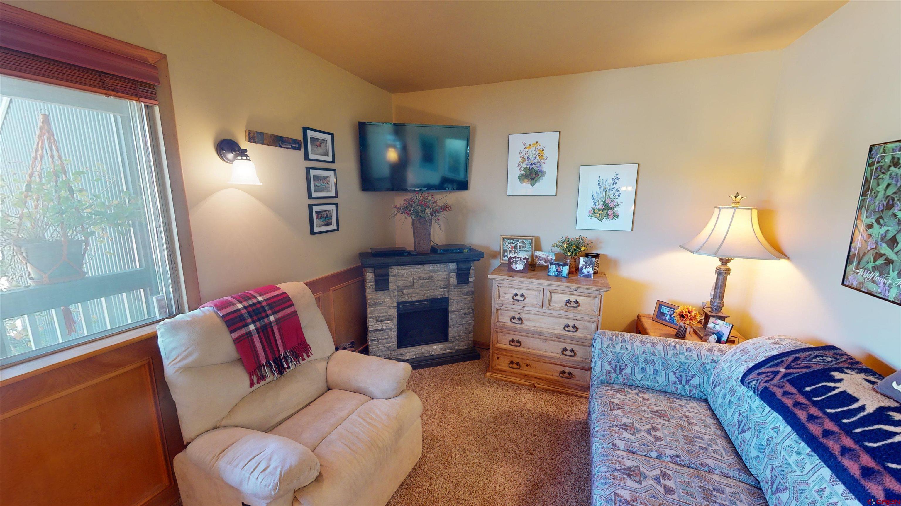 18 Crystal Road, Unit 2C Crested Butte, CO 81225 - Photo 2 of 23 a bedroom with furniture and a lamp