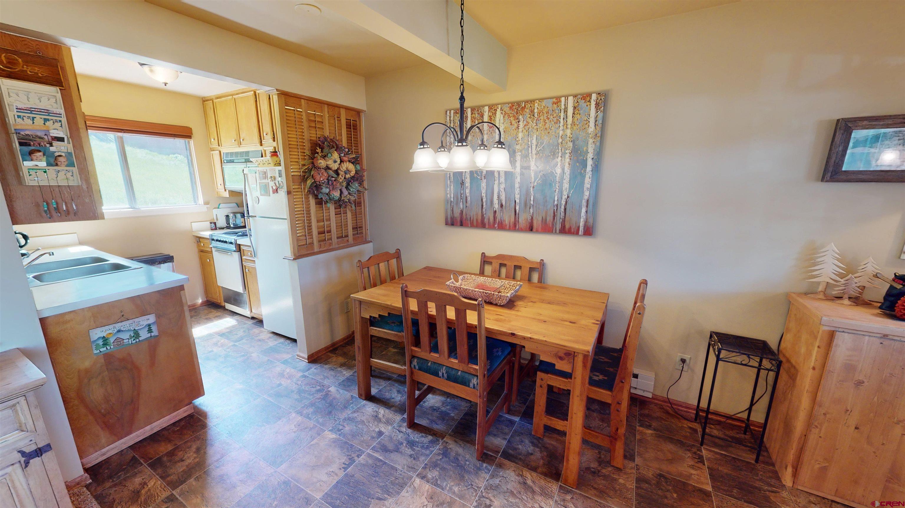 18 Crystal Road, Unit 2C Crested Butte, CO 81225 - Photo 6 of 23 a view of a dining room with furniture and wooden floor