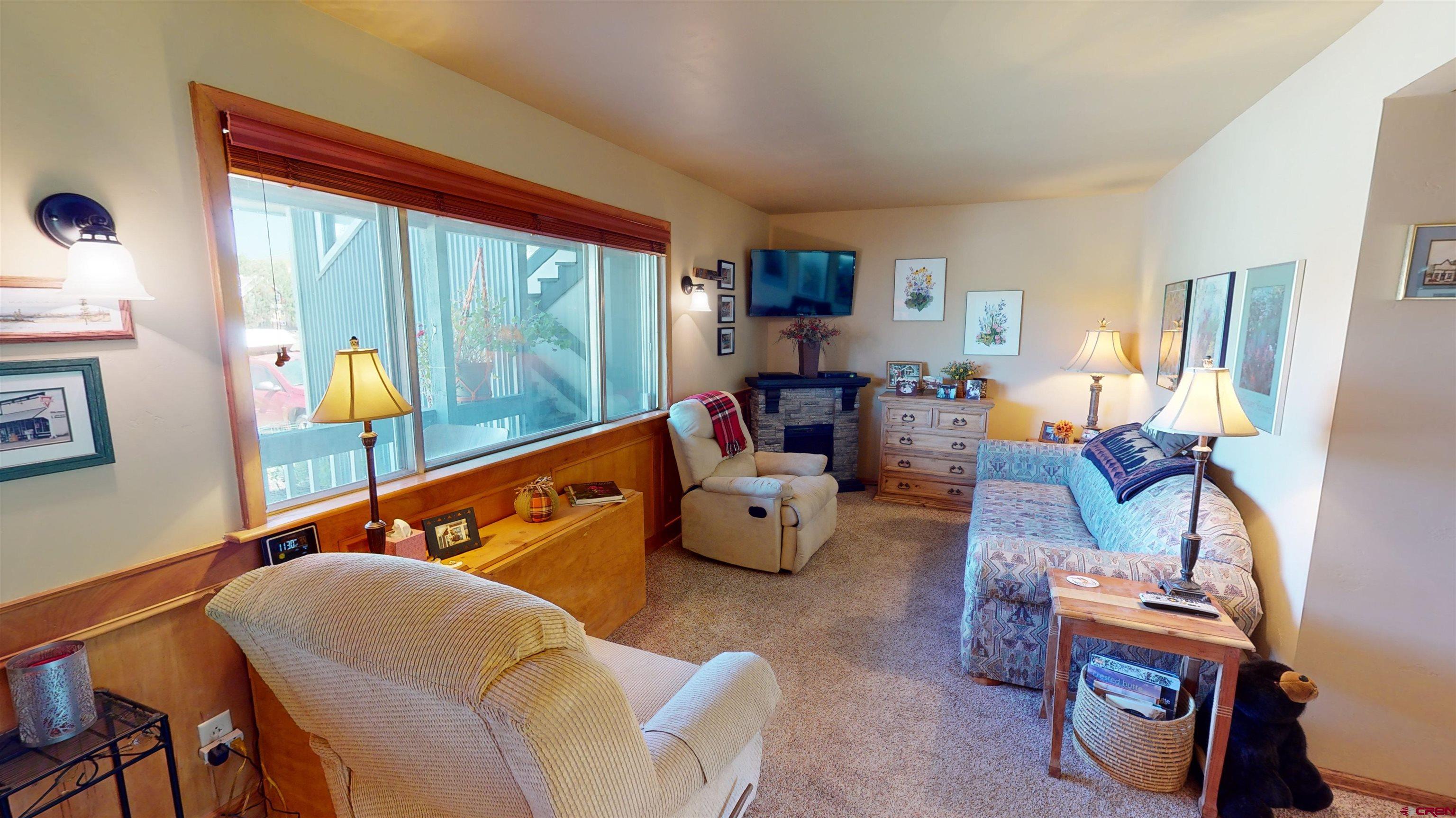 18 Crystal Road, Unit 2C Crested Butte, CO 81225 - Photo 7 of 23 a living room with furniture and a large window