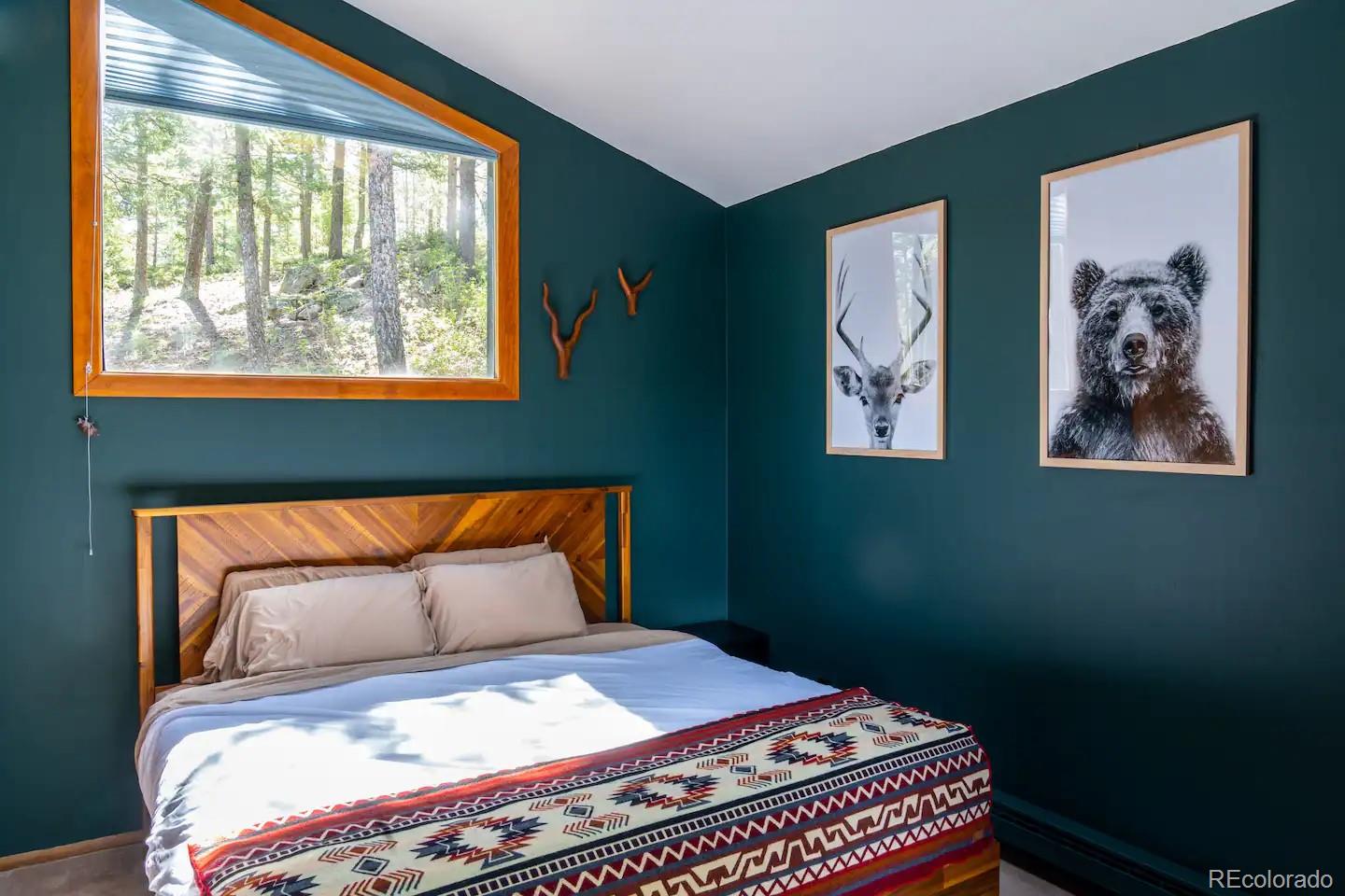 25756 Zugspitz Road Evergreen, CO 80439 - Photo 12 of 43 a bedroom with a bed and a window