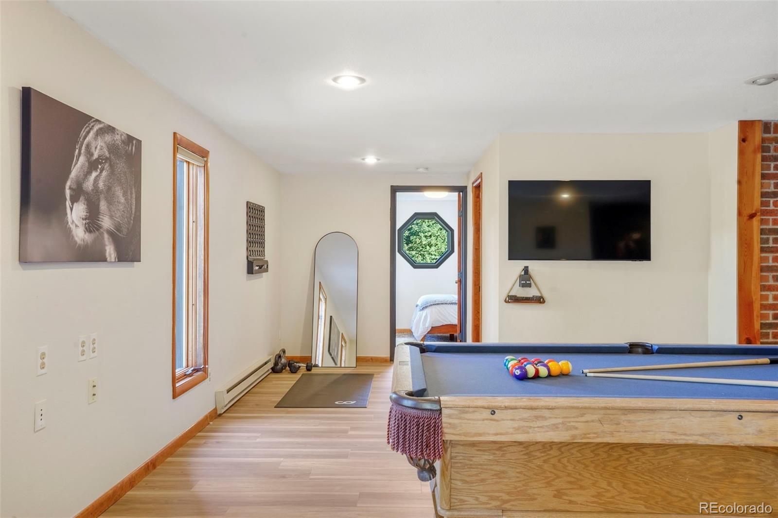 25756 Zugspitz Road Evergreen, CO 80439 - Photo 26 of 43 a view of living room with furniture and flat screen tv