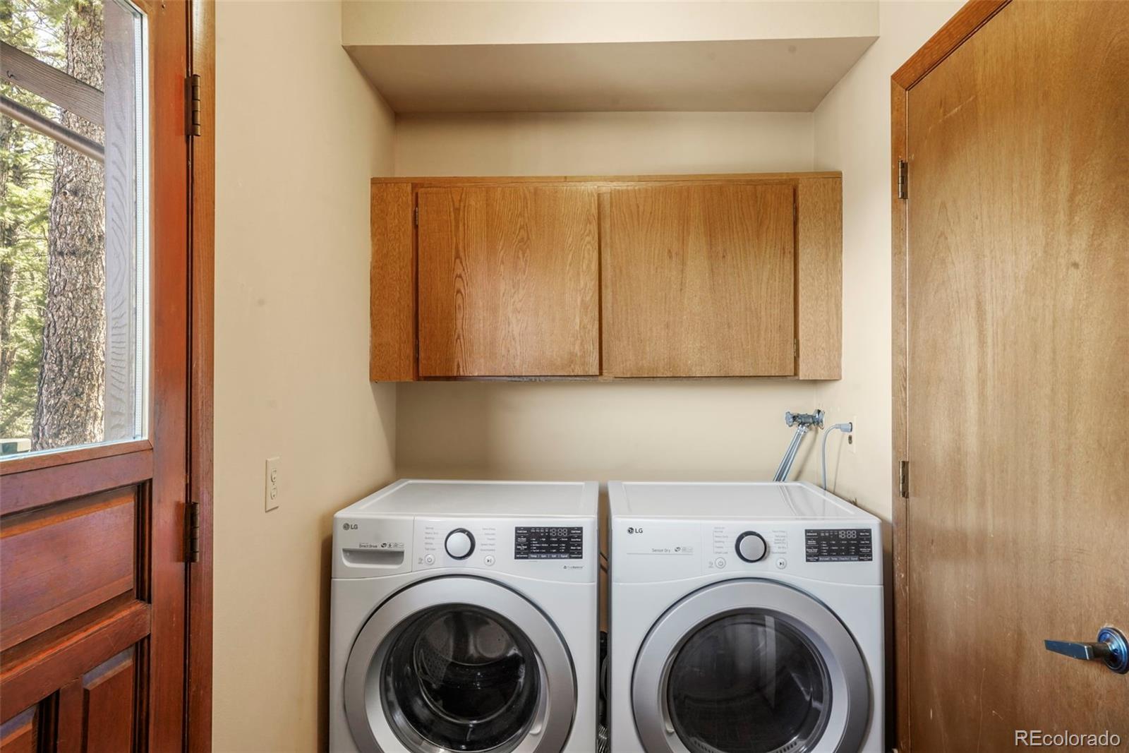 25756 Zugspitz Road Evergreen, CO 80439 - Photo 29 of 43 a utility room with dryer and washer