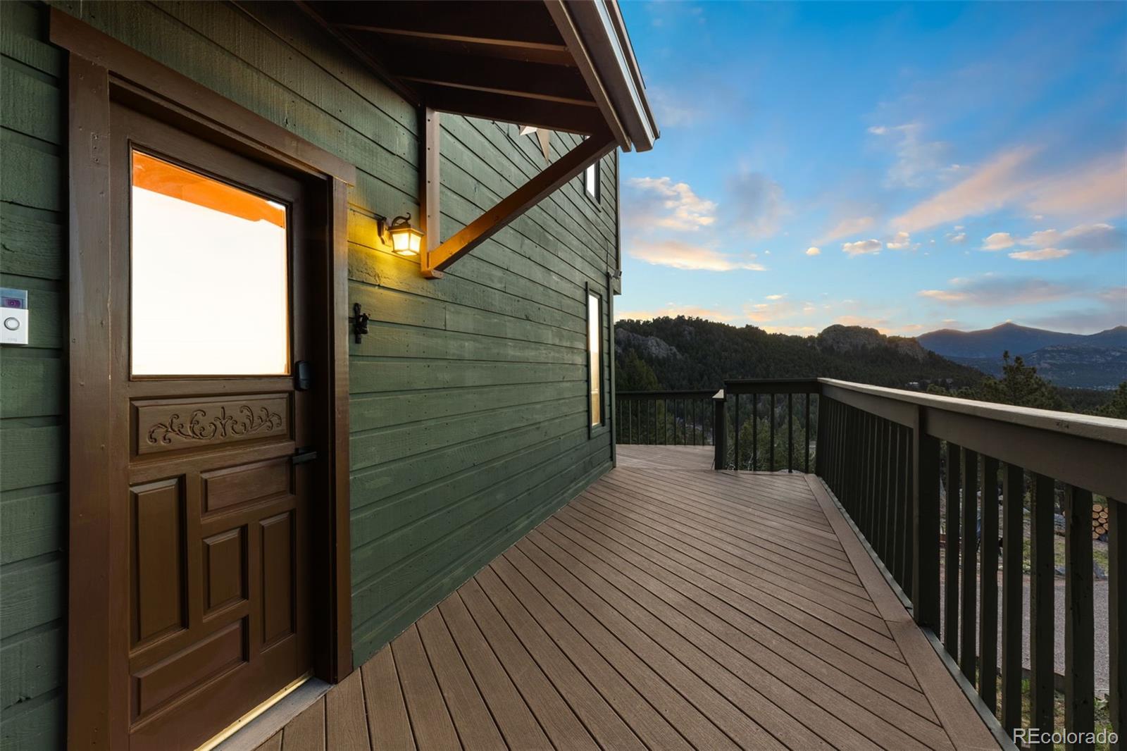 25756 Zugspitz Road Evergreen, CO 80439 - Photo 36 of 43 a view of a balcony with wooden floor and fence