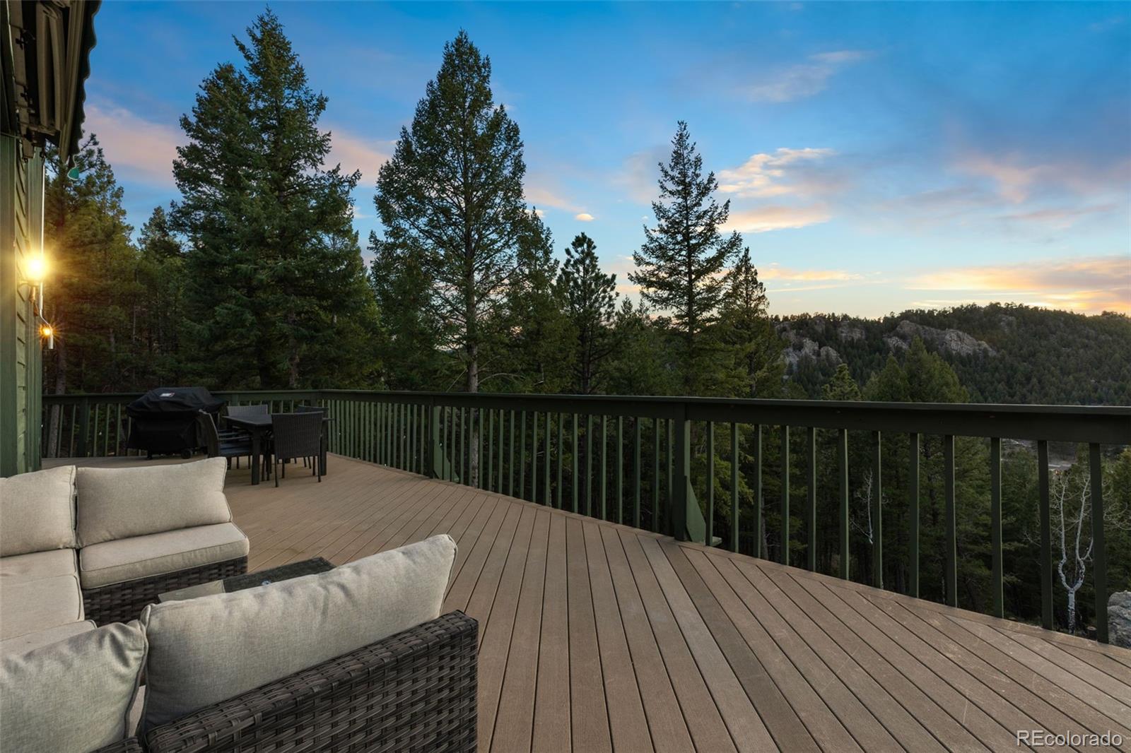 25756 Zugspitz Road Evergreen, CO 80439 - Photo 37 of 43 a balcony with wooden floor and outdoor space