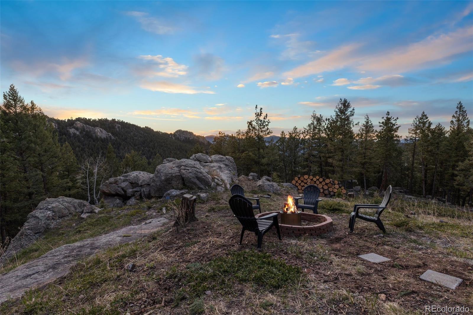25756 Zugspitz Road Evergreen, CO 80439 - Photo 41 of 43 a view of a backyard with sitting area