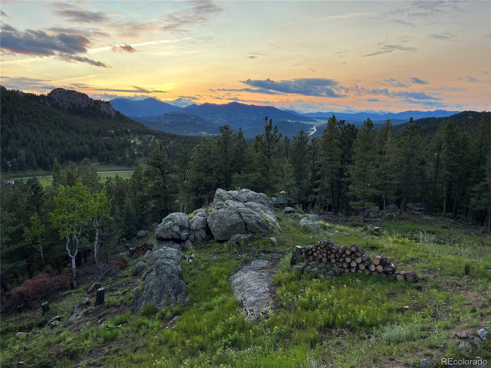 25756 Zugspitz Road Evergreen, CO 80439 - Photo 42 of 43 a view of a lush green hillside and houses