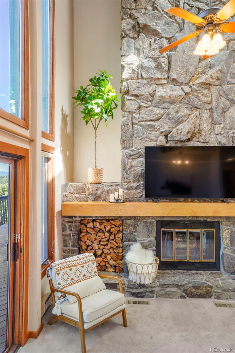 25756 Zugspitz Road Evergreen, CO 80439 - Photo 7 of 43 a living room with furniture and a fireplace