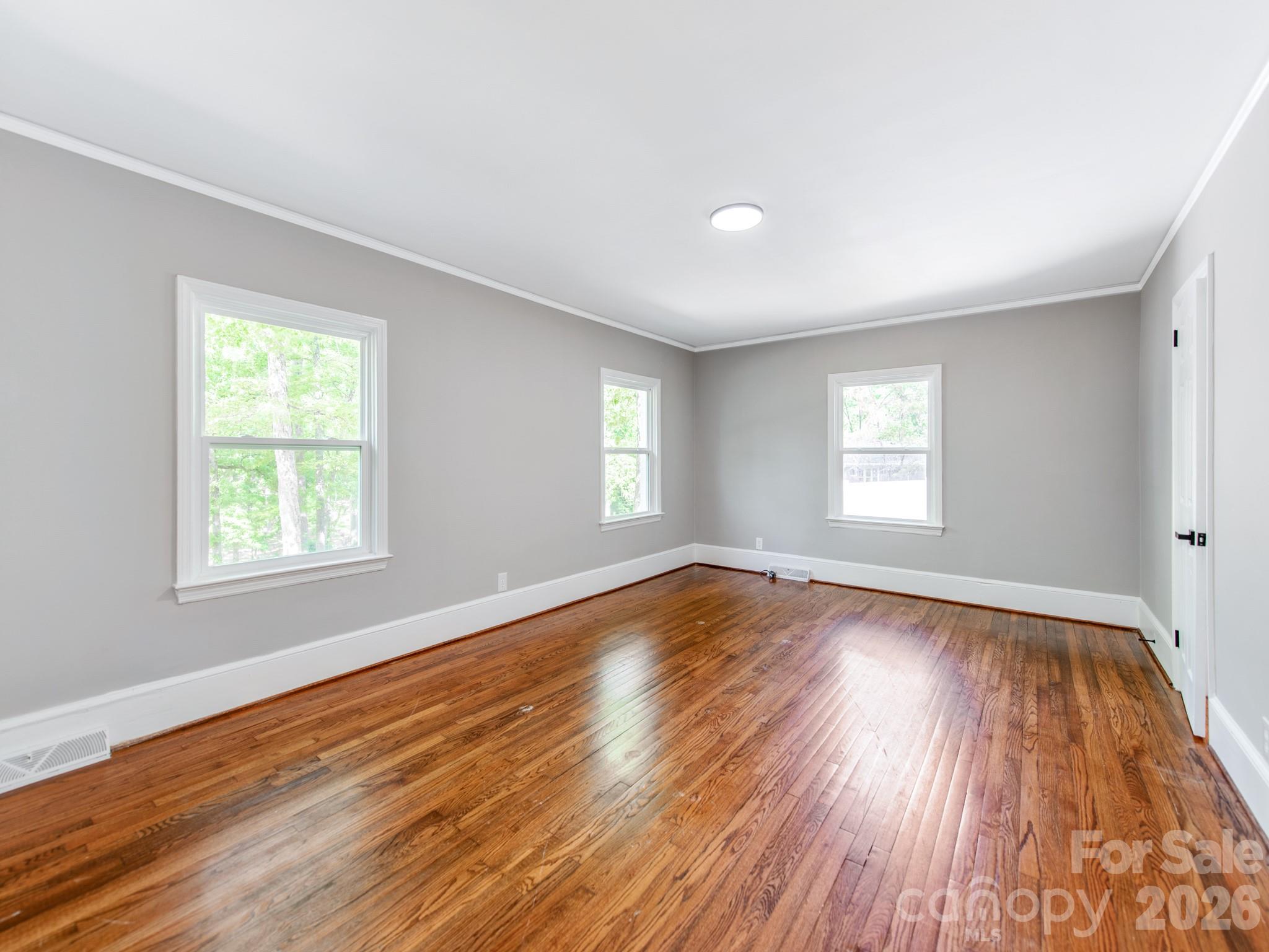 120 Sunset Drive Chester, SC 29706 - Photo 17 of 34 a view of empty room with window and wooden floor