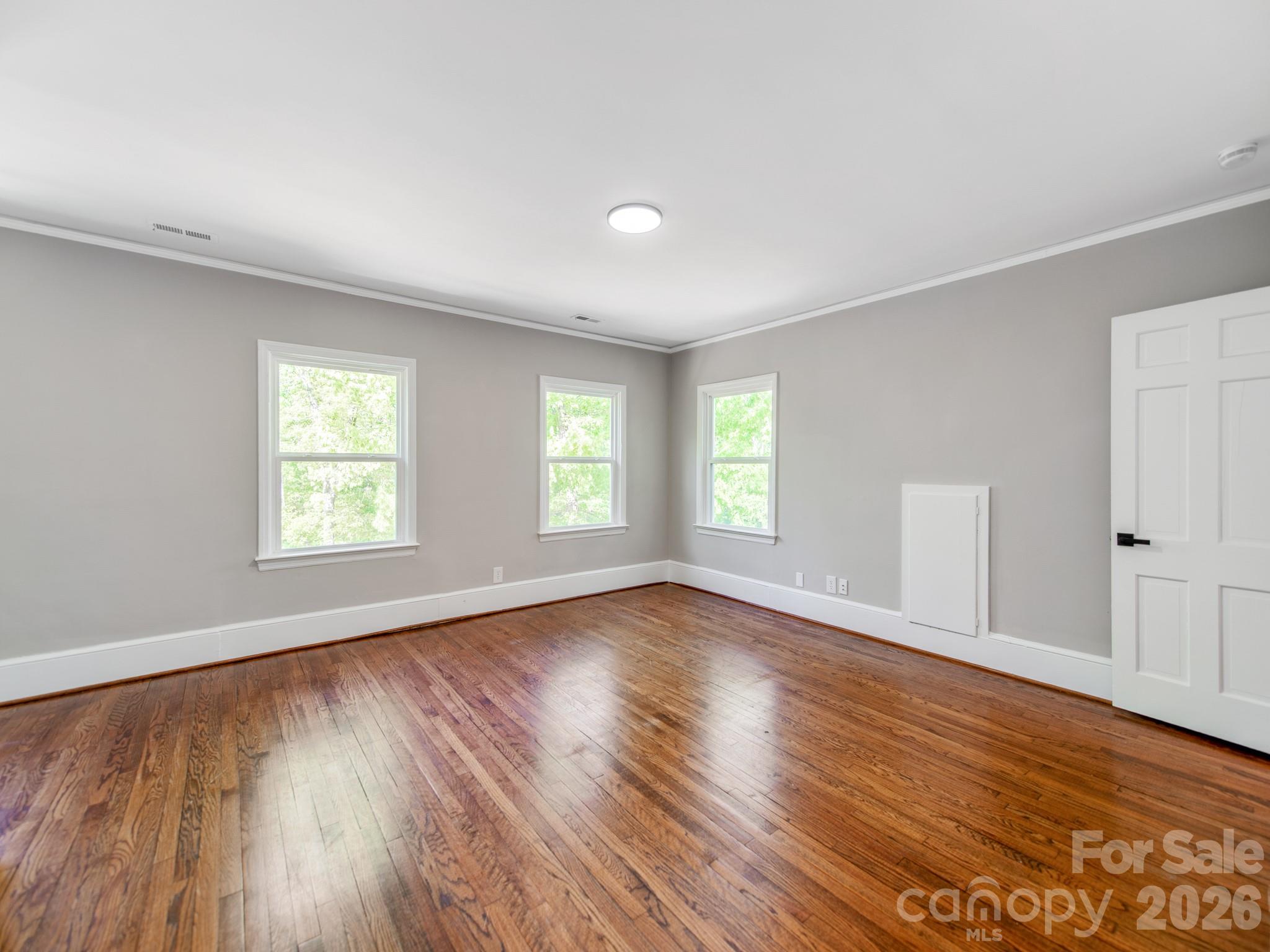 120 Sunset Drive Chester, SC 29706 - Photo 21 of 34 an empty room with wooden floor and windows