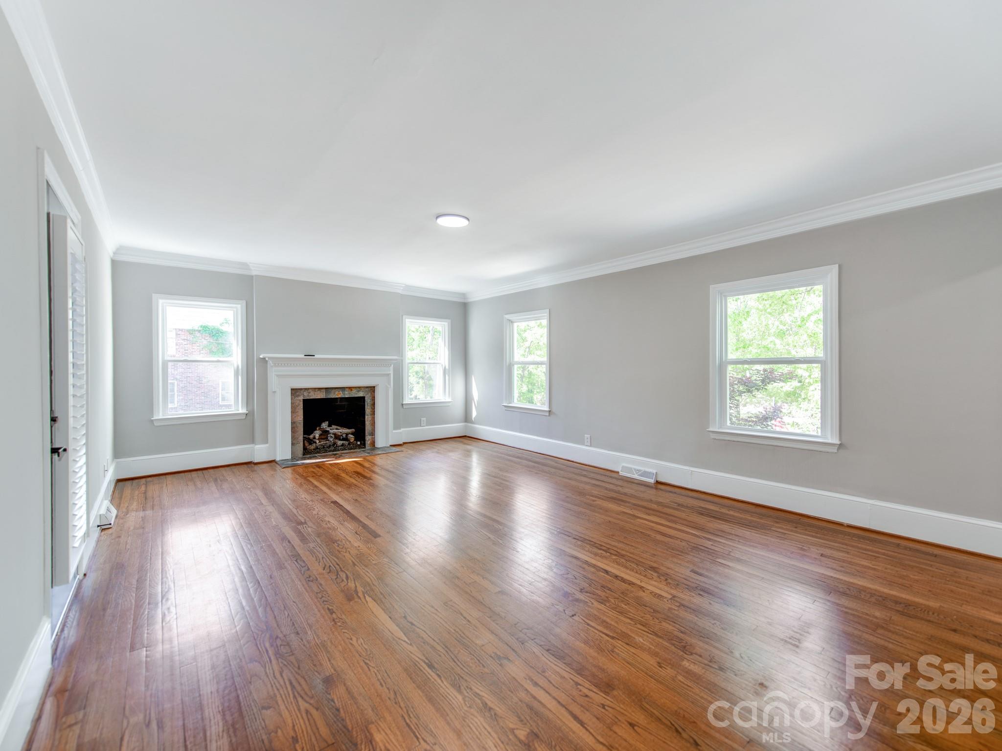 120 Sunset Drive Chester, SC 29706 - Photo 7 of 34 an empty room with wooden floor fireplace and windows