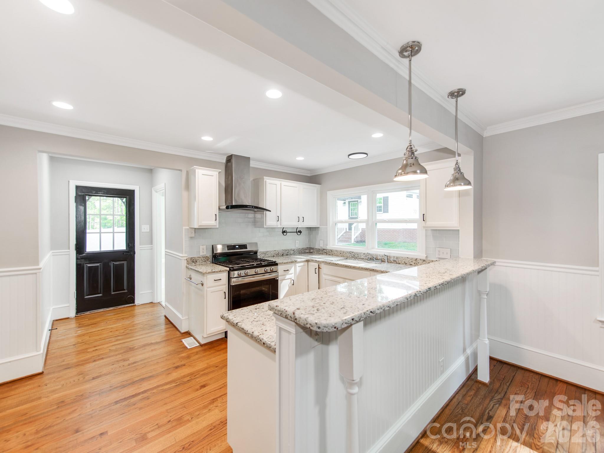 120 Sunset Drive Chester, SC 29706 - Photo 10 of 34 a kitchen with granite countertop kitchen island wooden floors granite counter tops and a window