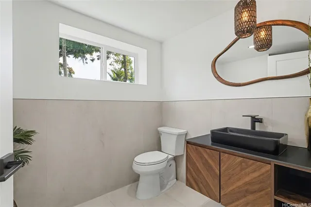 a bathroom with a toilet a sink and mirror