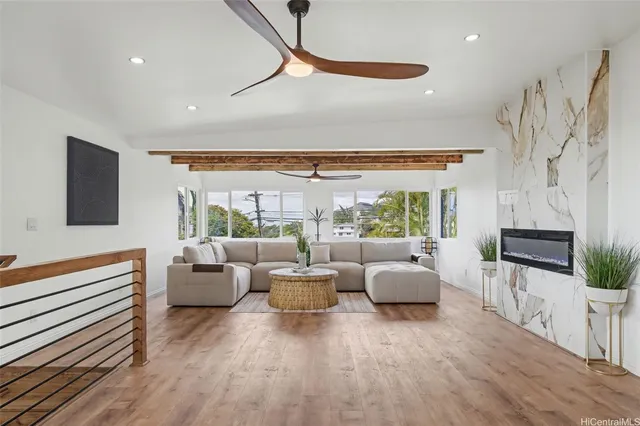 a living room with furniture and a floor to ceiling window