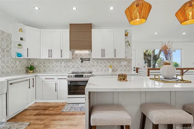 a kitchen with stainless steel appliances granite countertop a sink stove and cabinets